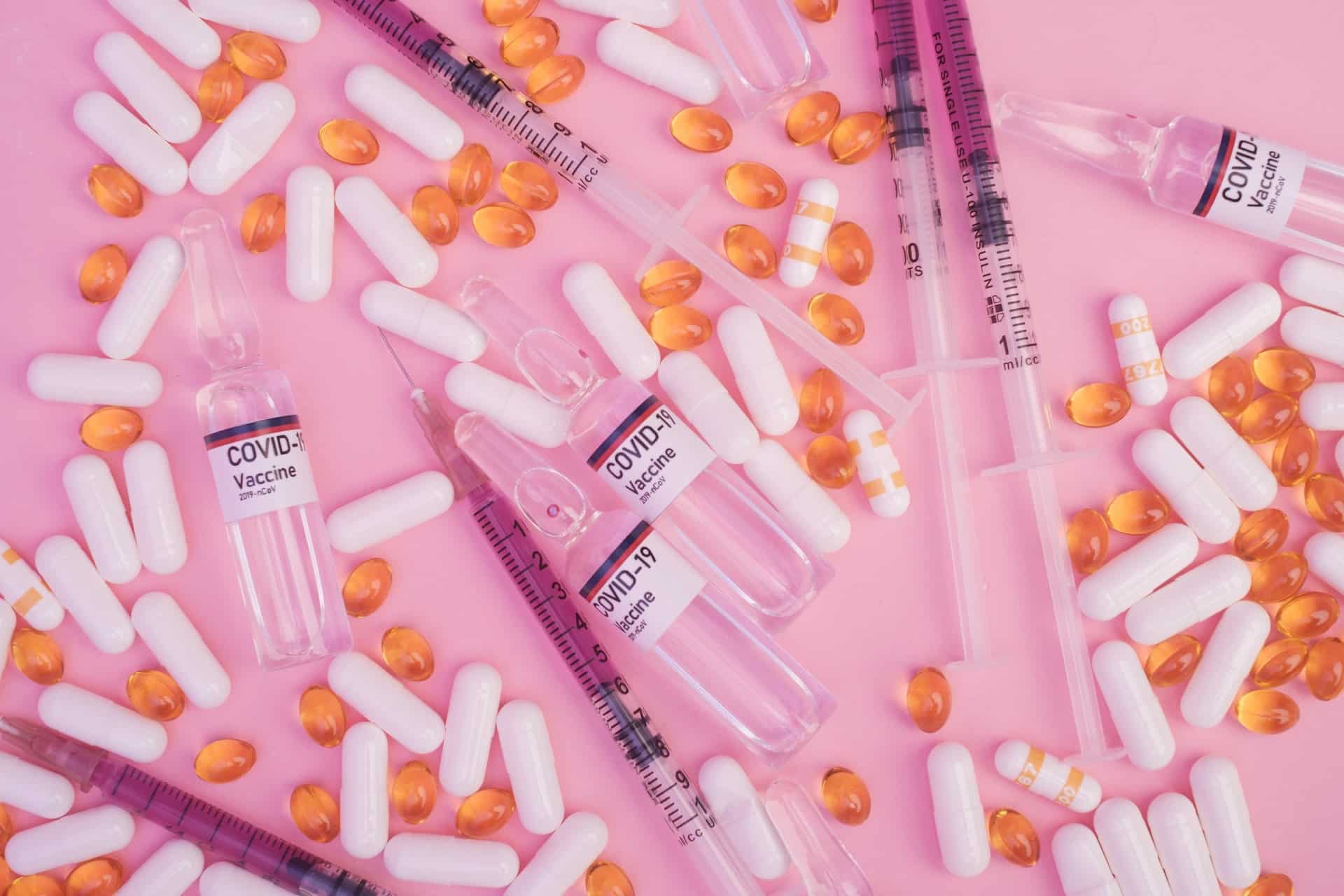 pexels-alena-shekhovtcova- photo of pills and needles on pink background