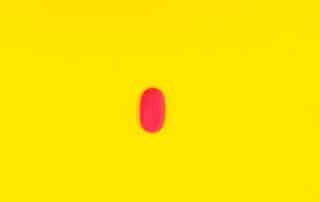 red pill on yellow background pexels-shvets-production-9743101