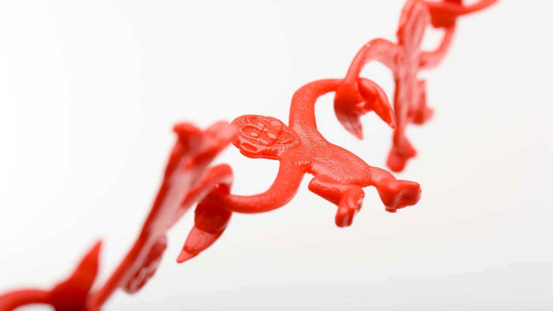 Red DNA strand with plastic monkey intertwined